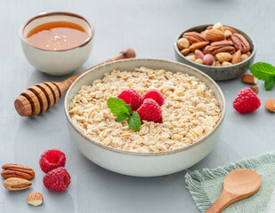 Bowl of porridge or oatmeal with fruits close up. Breakfast concept.