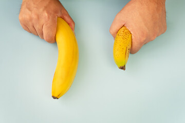 Small Banana compare size wish banana on blue background. Sexual life libido, penis size and...