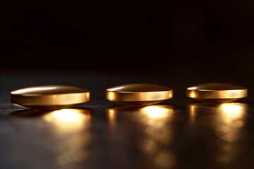 Golden capsule pharmaceutical vitamin D supplement, fish oil. Medical and health concept illustration