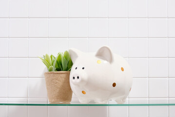 Financial security and investment concept. Piggy bank and a green plant in an ecological pot.