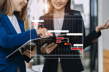 Business woman hand Project manager working and update tasks and Gantt chart scheduling virtual diagram.