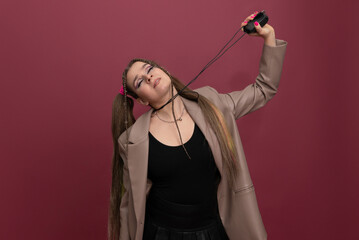Beautiful young woman with lots of computer cables over her head, peeking behind a computer mouse