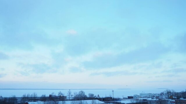 Lake Onega, Petrozavodsk, Karelia. Industrial landscape. Frosty winter. Blue sky clouds. Slow motion. Real time. View of the ice-frozen lake from Klyuchevaya. Ivanovo Islands, Baraniy Bereg Peninsula