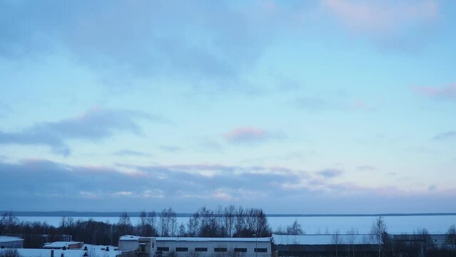 Lake Onega, Petrozavodsk, Karelia. Industrial landscape. Frosty winter. Blue sky clouds. Slow motion. Real time. View of the ice-frozen lake from Klyuchevaya. Ivanovo Islands, Baraniy Bereg Peninsula