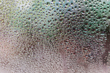 Fototapeta premium Foggy glass with water vapor, fog, flowing. Window with water drops Raindrops on a dark background