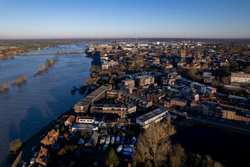 Fototapeta premium Cityscape aerial during extreme high water level of river IJssel in Zutphen, The Netherlands. Weather and climate concept.