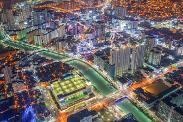 night scape of the city. Colorful buildings, roads, and city night view from the bifc observatory in Busan, Korea.