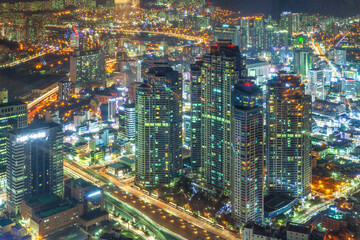 night scape of the city. Colorful buildings, roads, and city night view from the bifc observatory in Busan, Korea.