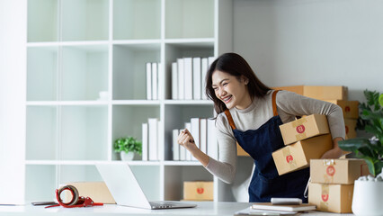 Young business woman entrepreneur online shipment business happy after preparing packages to send...