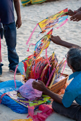 A picture of person selling kites in a beach