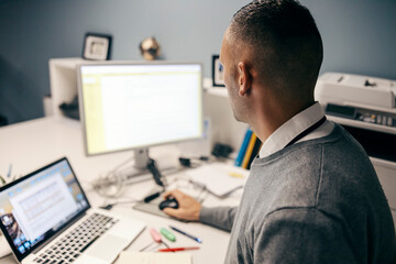 Fototapeta na wymiar Rear view of an executive using a computer.