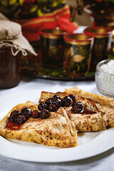 Pancakes with black currant jam on a plate, Ukrainian  or Russian style