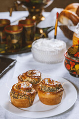 Baked buns with poppy seeds on a white tablecloth. Ukrainian  or Russian style