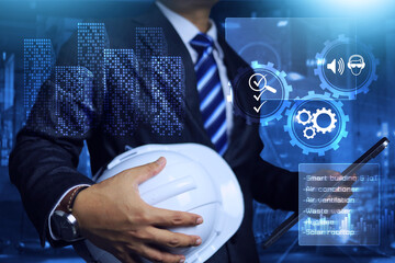 Engineer holding safety helmet and tablet to building inspection with technology on smart building...