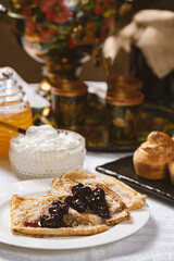 Pancakes with black currant jam on a plate, Ukrainian  or Russian style