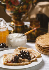 Pancakes with black currant jam on a plate, Ukrainian  or Russian style