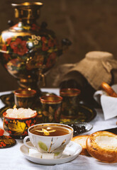 Cup of tea with lemon and honey on a wooden background. Ukrainian  or Russian style