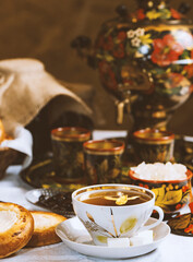 Cup of tea with lemon and honey on a wooden background. Ukrainian  or Russian style