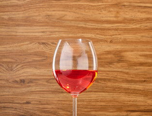 A beautiful glass with an alcoholic holiday drink on a wooden background. Festive mood.