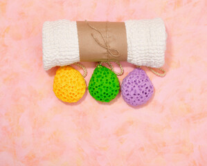 A white shower towel and colorful washcloths. Copy space for text, top view.