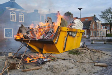 A burning yellow container with heavy smoke on New Year's Day in a village in the Netherlands