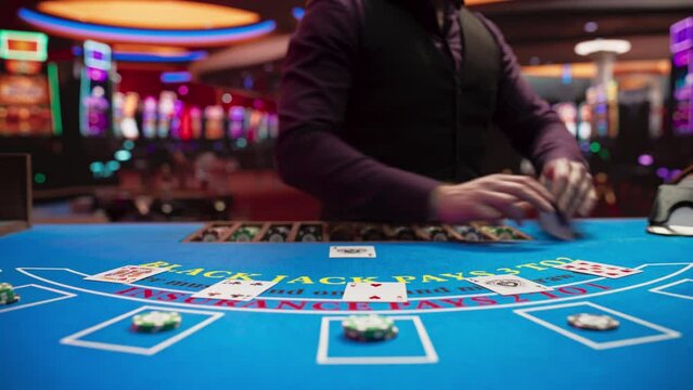 Online Casino: Professional Croupier Deals Cards on Blackjack Table. Anonymous Dealer Masterfully Revealing Jackpot Possibly Winning Hand, Excitement in High-Stakes Game for Payout. Close-Up Tilt Shot