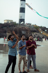 Fototapeta na wymiar Indian guys trying to fly kite in a beach