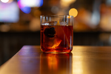 Close up of classic negroni cocktail. Alcoholic drink with gin, vermouth, and campari