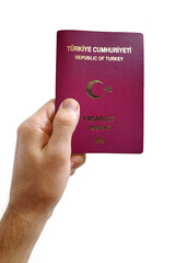 Man's hand holding a Turkish passport