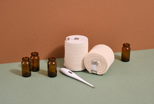 Elastic bandages, thermometer and empty glass jars for medications.