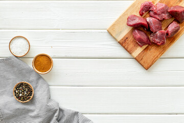 Beef meat on wooden board ready for cooking. Food background