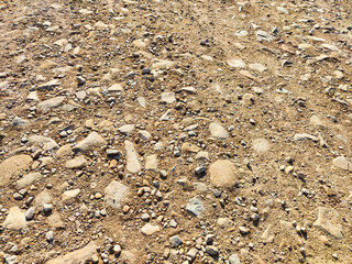 Texture and background of podzol soil with pebbles. Abstract Earth and stone as a place for text...