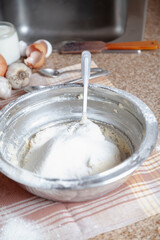 Fototapeta na wymiar Bowl with flour and spoon on a napkin....