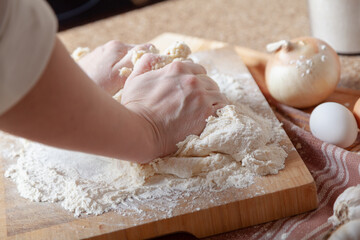 Women hands knead dough....