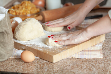 Female hands pressing two pieces of dough....