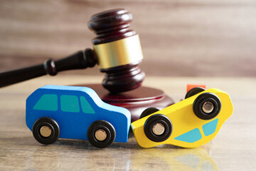 Car accident lawsuit and insurance, Judge hammer with car model.