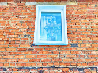 Front view of new plastic windows in an old red brick wall. Abstract background, texture, pattern, copy space and place for text