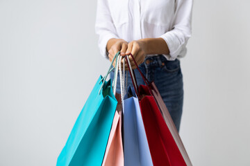 Woman hand holding shopping bags isolated on white