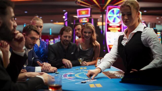 Group of Casino Goers Enjoying Time in a Modern Casino, Friends Placing Blackjack Bets, Professional Female Croupier Deals Cards. Diverse Group People Playing, Placing Bets Winning and Celebrating