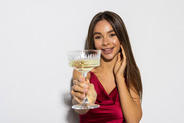 Portrait, champagne and toast with a woman in red isolated on white background at an event, party or gala.