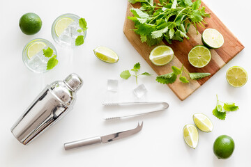 Alcoholic drink mojito making in blender with mint and lime, top view