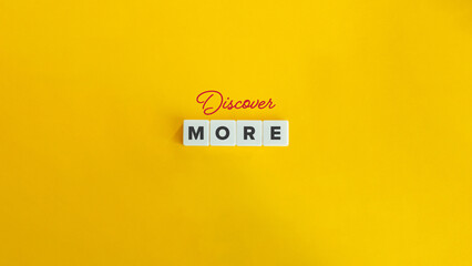 Discover More Banner. Block Letter Tiles and Cursive Text on Flat Yellow Orange Background....
