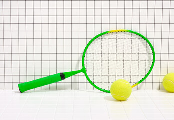 Green racket and tennis yellow brightly colored balls. Concept of sport healthy lifestyle.