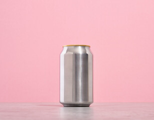 One shiny aluminum can of drink stands on the table.