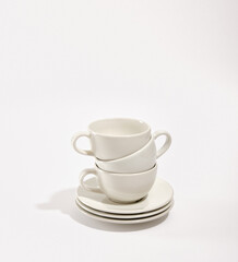 Set of clean luxury white cookware. Clean washed plates and cups.