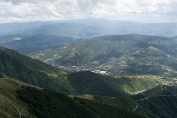 Fototapeta premium Landscape with mountains and villages in valley during sunny day with dramatic clouds, mountain Vlasic near Travnik