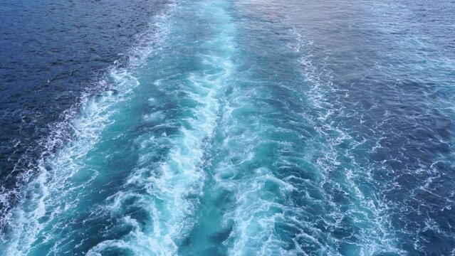 Blue stern waves on the ocean, beautiful pattern on the foamy water surface. 4k