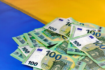 Financial Aid for Ukraine. Finance Assistance, Donation, Investments Euro Money on Ukrainian Flag Background.