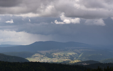 Fototapeta na wymiar Downpour over mountain and gloomy clouds, view from Vlasic mountain