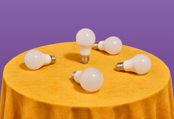 A few light bulbs on a yellow table. Interior and lighting.